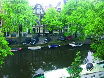 View of boats and barges, some inhabited, on the Brouwersgracht in Amsterdam, photographed from one of the many apartments available for rent in the city.