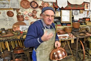 A coppersmith in Montepulciano, Italy. Photo by Cameron Hewitt